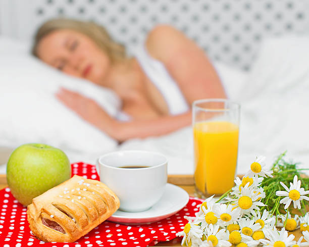 istock Breakfast in bed. Sleeping woman on background. 484062806