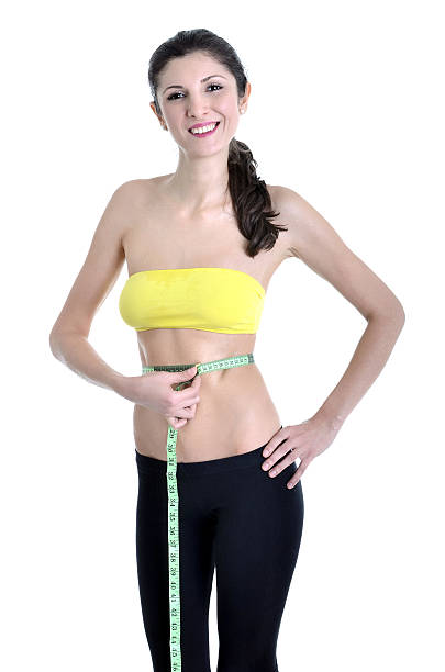 istock Beautiful woman measuring perfect body shape 484064781