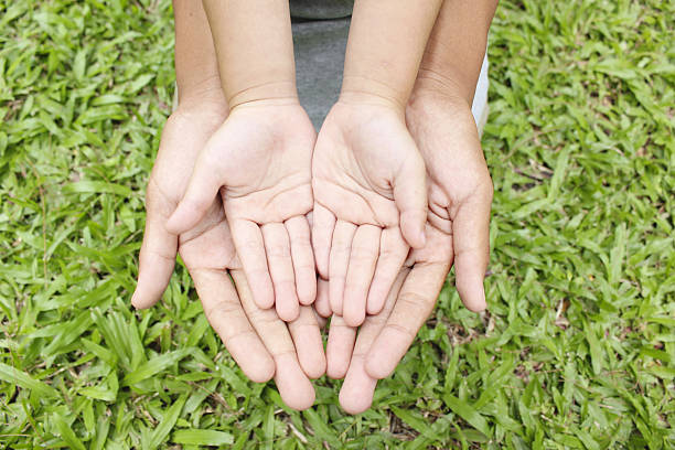istock Adult hands holding kid hands 484065034