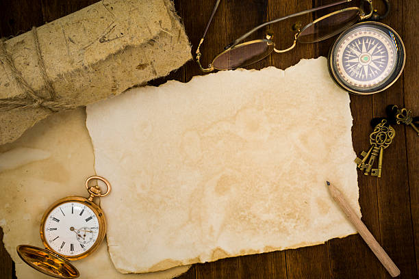 istock Old paper, compass, pocket watch on wooden background 484066714