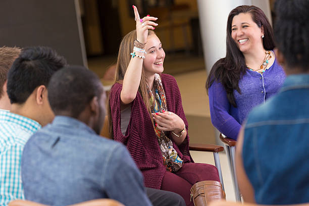 istock Teenager pointing up while discussing spiritual issues in group 484067021