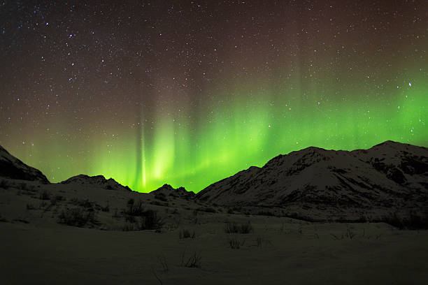 Aurora Borealis with red and green streaks Aurora Borealis over the Talkeetna Mountain's Hatcher Pass, Alaska. talkeetna mountains stock pictures, royalty-free photos & images