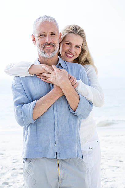 istock Happy couple hugging each other and looking at camera 484068194