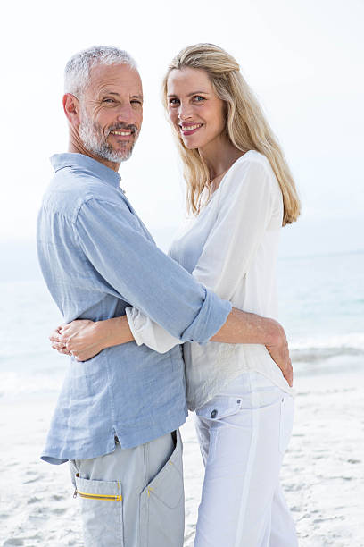istock Happy couple hugging each other and looking at camera 484068196