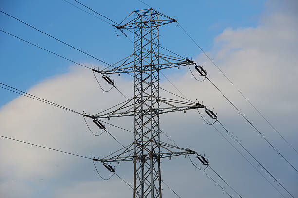 istock electricity transmission pylon silhouetted against blue sky 484068500