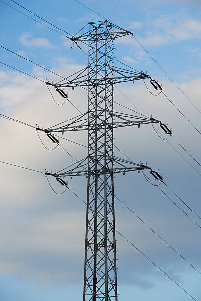 istock electricity transmission pylon silhouetted against blue sky 484068502