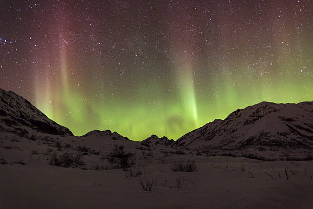 Aurora Borealis with red and green streaks Aurora Borealis over the Talkeetna Mountain's Hatcher Pass, Alaska. talkeetna mountains stock pictures, royalty-free photos & images