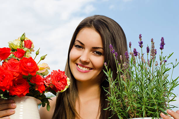 Beautiful woman in the garden with flowers. stock photo