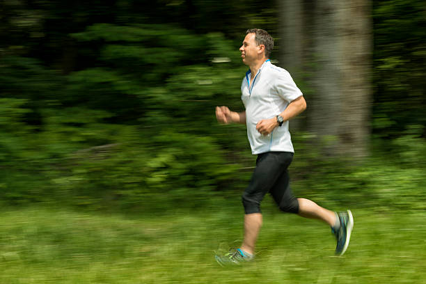 istock mature man running in nature 484071860
