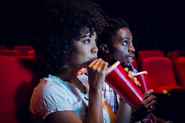 Young couple watching a film at the cinema