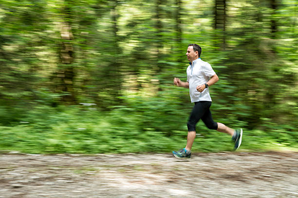istock mature man running in nature 484072158