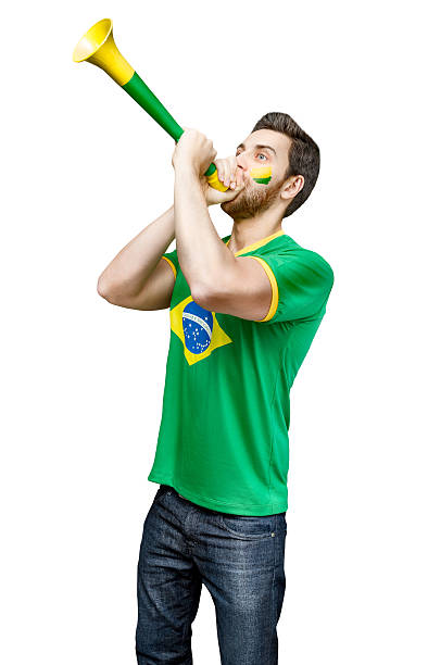 istock Brazilian fan celebrates on white background 484072596
