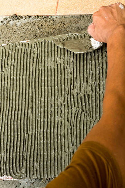 istock Tiler at work. bonding of floor tile 484072824