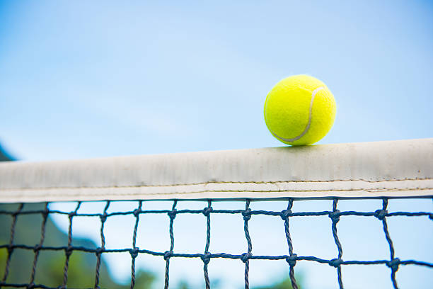 istock tennis ball with net 484076568