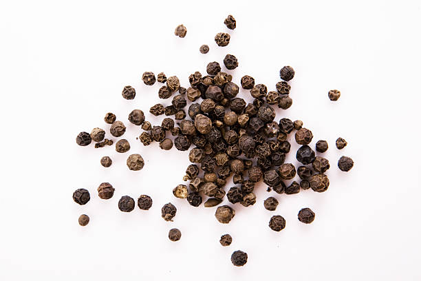 Black pepper Black pepper seeds on white black peppercorn photos stock pictures, royalty-free photos & images