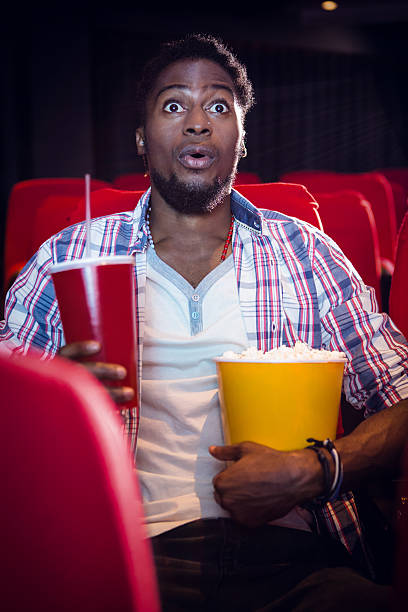 istock Happy young man watching a film 484076826