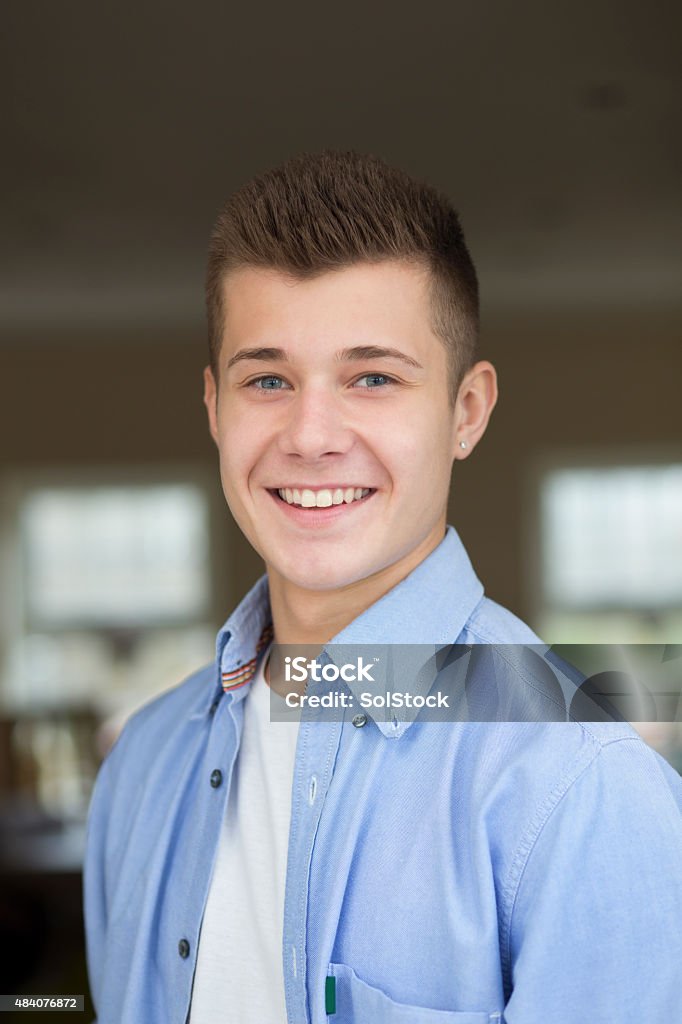 Teenage boy headshot Headshot of a teenage boy at home. He is wearing casual clothing and is looking at the camera and smiling. 18-19 Years Stock Photo