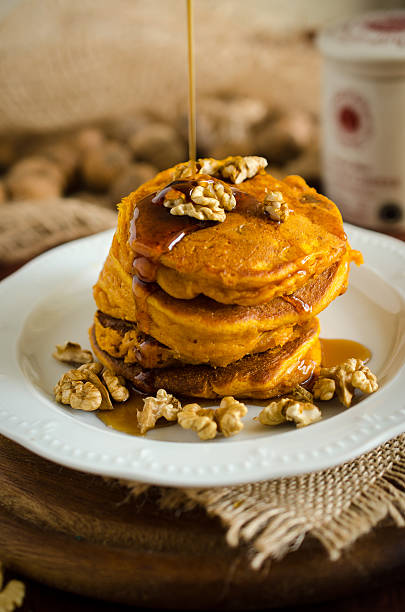 istock Pumpkin pancakes with hazelnuts and maple syrup / honey 484077050