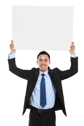 smiling asian business man holding empty board. ready for your design