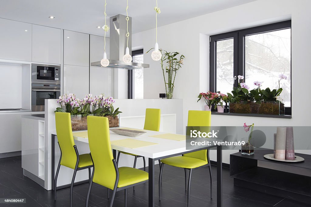 Contemporary kitchen interior White kitchen interior with orchid flowers Apartment Stock Photo