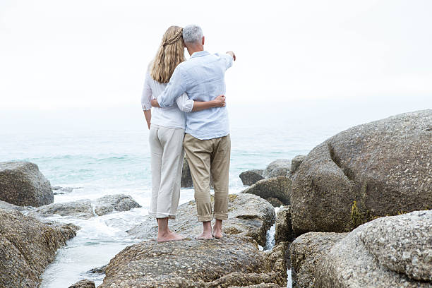 istock Happy couple standing on the rock 484080732