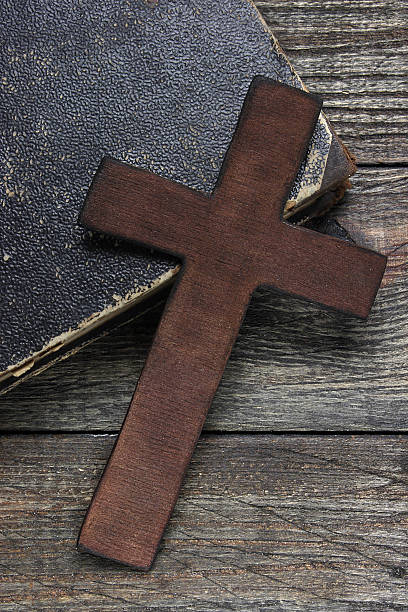 istock Cross and old book on wooden table 484081007