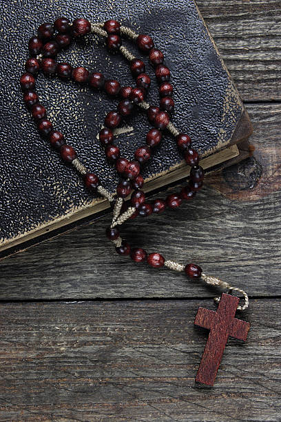 istock Rosary and old book on a wooden table 484081015