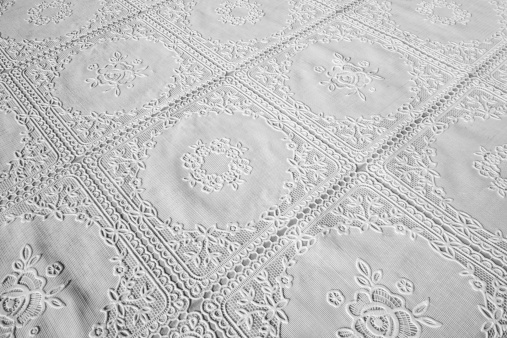detail of a beautifull ornated white tablecloth