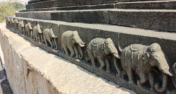 Stone carved sculptures on wall of Mahanavami Dibba in royal enclosure in Hampi, Karnataka, India