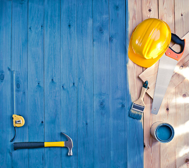 istock blue wood floor with a brush, paint, tools and helmet 484082319