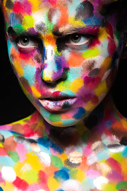 istock Girl with colored face painted. Art beauty image 484083072