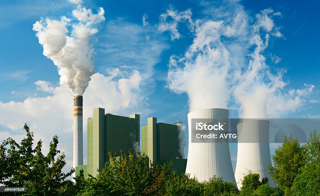 Coal Power Plant Smoking and Steaming against Blue Sky Coal Stock Photo