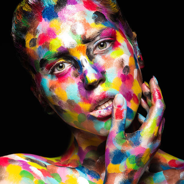 istock Girl with colored face painted. Art beauty image 484090472