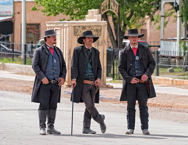 Gunfight At OK Coral Tombstone , Arizona, USA - May 11, 2015 : Actors representing Wyatt Earp, Virgil Earp and Doc Holiday take part in the Reenactment of the OK Corral gunfight in Tombstone, Arizona. wild west gunfight stock pictures, royalty-free photos & images