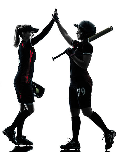 istock women playing softball players silhouette isolated 484091612
