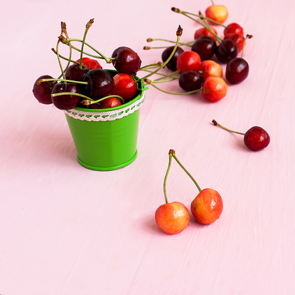 Ripe cherries on the table in a bucket
