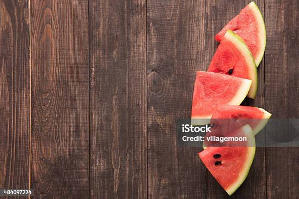 Fresh Watermelon Pieces Placed On Wooden Background Stock Photo - Download Image Now