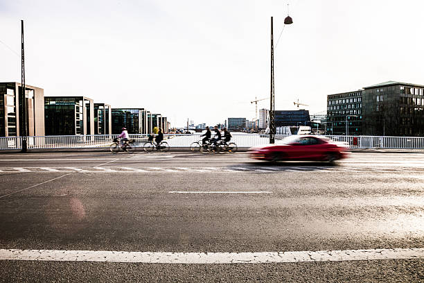 People cycling in Copenhagen In Copenhagen, the capital of Denmark, the traffic is mostly from cyclist, that's incredible to see how many people cycling on the street during the all day. car city urban scene commuter stock pictures, royalty-free photos & images