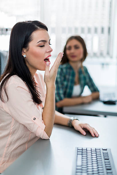 istock Young beautiful girl yawning during class 484100726