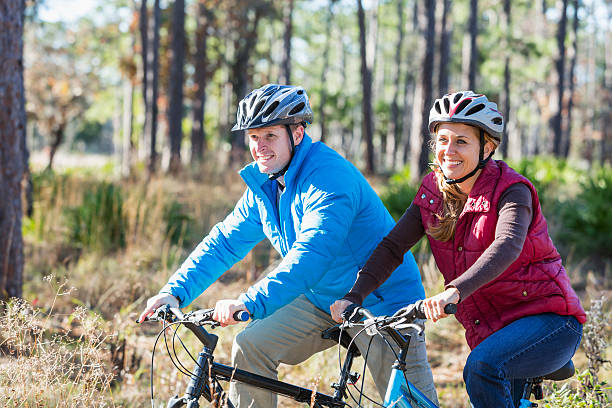 istock Couple biking in the park on chilly autumn day 484101120
