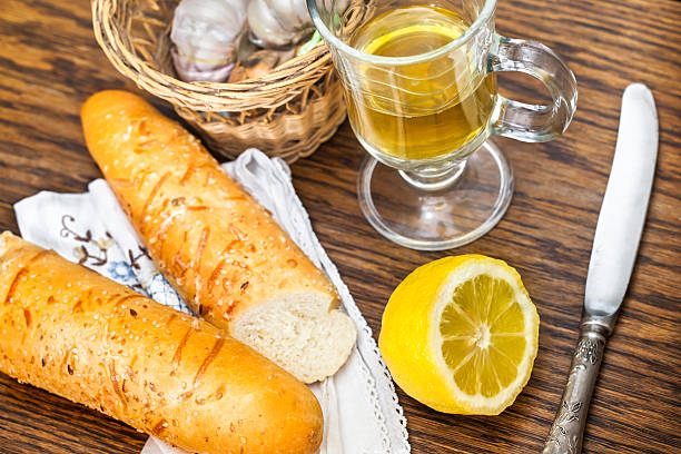 baguette and tea with lemon for breakfast stock photo