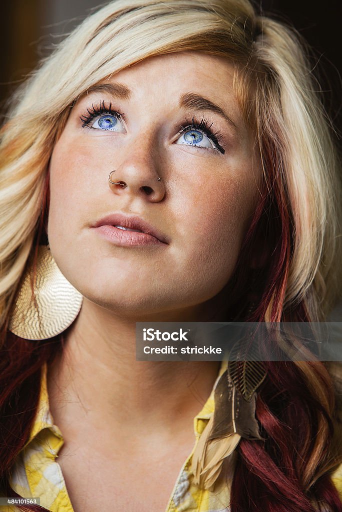 Casual Beauty Blond Looks Skyward Expectantly A blue-eyed beauty looks up with optimistic expectancy. Candid Stock Photo