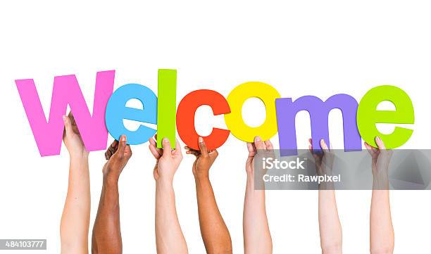 Multiethnic Group Of People Holding The Word Welcome Stock Photo - Download Image Now