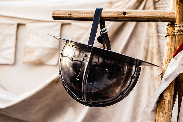 Hanged helm medieval shields, helm and weapons in a medieval fair in italy Faceplate stock pictures, royalty-free photos & images