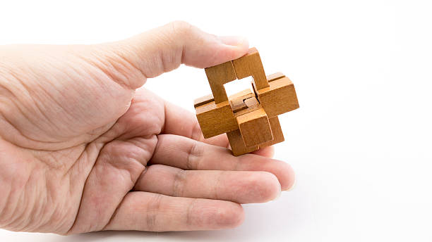 istock Hand holding piece of wooden block cube puzzle. 484104334