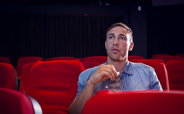 istock Young man watching a film 484104434