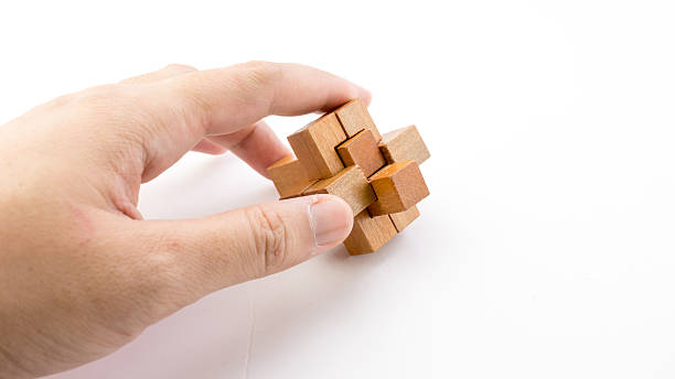 istock Hand holding piece of wooden block cube puzzle. 484104536