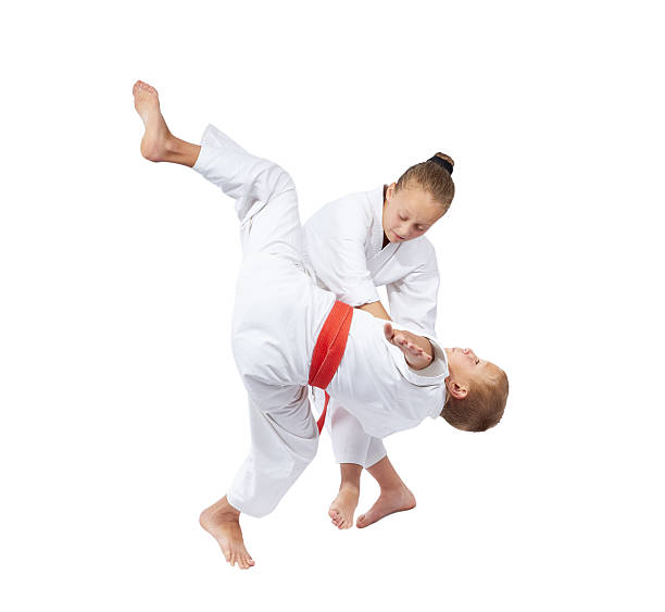istock With white belt sportswoman is doing throw judo 484105122