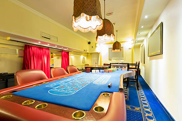 istock Blackjack and roulette tables at casino 484105130