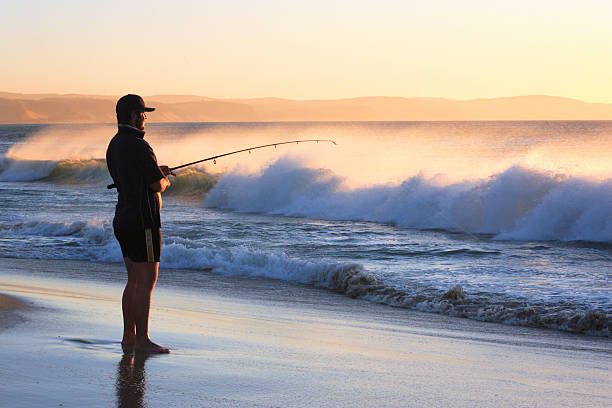 Carrickalinga, South Australia, Australia, January 25, 2009: Man Fishing on Carrickalinga Beach, a favourite place to Fish for the prized Australian Salmon.     